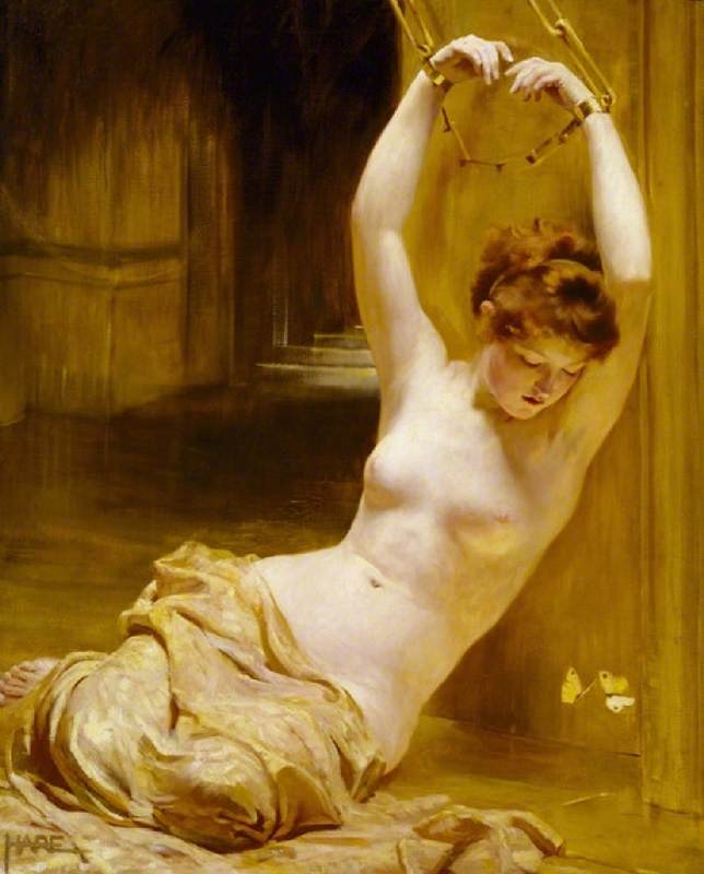 Oil painting by Saint George Hare (1908) of a nude brown-haired woman with a cloth over her hips, seated in a dungeon, with hands over her head cuffed.